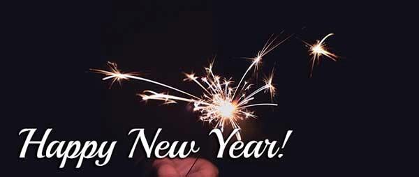 Black background with hand holding a sparkler and Happy New Year